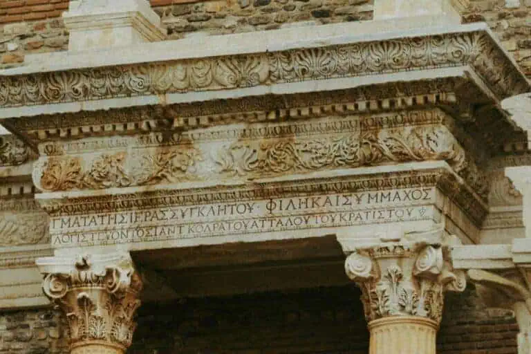 ancient greek inscription carved on a stone building facade