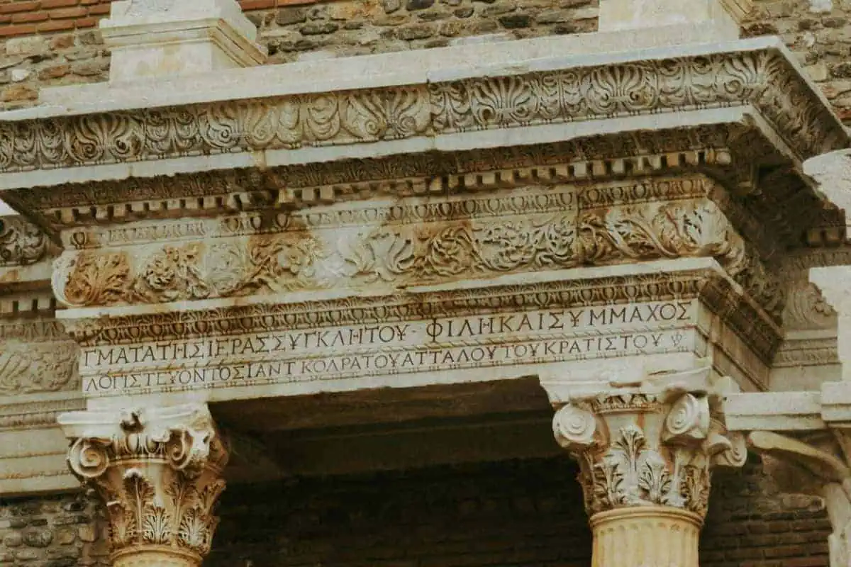 ancient greek inscription carved on a stone building facade